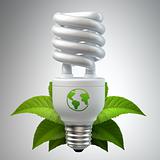 White energy saving light bulb with leafs on white