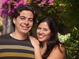 Attractive Hispanic Couple Portrait Enjoying Each Other Outdoors.