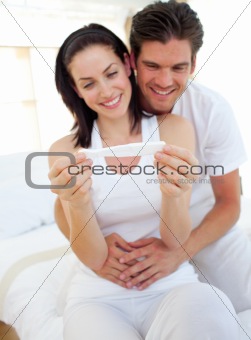 Smiling couple finding out results of a pregnancy test