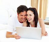 Affectionate couple using laptop