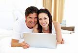 Loving couple using laptop