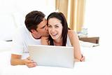 Intimate lovers using laptop