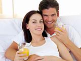 Romantic couple drinking orange juice