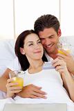 Intimate couple drinking orange juice