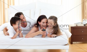 Joyful family having fun in the bedroom