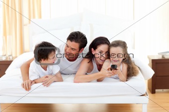 Happy family having fun in the bedroom 