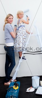 Mother and her daughter painting together 