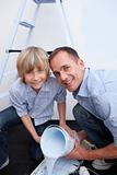 Portrait of smiling father and his son preparing paint