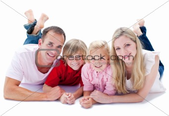 Lively family lying on the floor against a white background