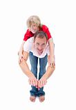 Smiling little boy enjoying piggyback ride with his father