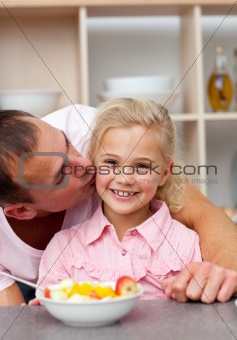 Caring father eating fruit with his daughter