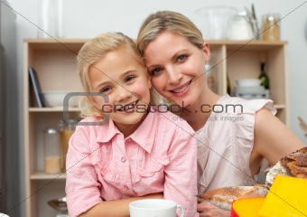 Jolly little girl eating fruit with her mother 