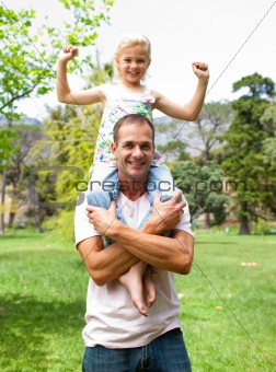 Jolly father giving his daughter piggy-back ride 