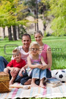 Smiling family having a picnic in a park