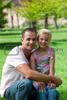 Smiling father and his daughter having a picnic
