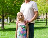 Cute little girl with her father in a park