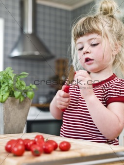 Girl cutting tomatoes