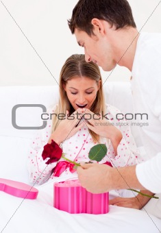 Bright husband giving a present to his wife