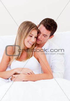 Portrait of a loving couple sitting on bed