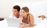 Intimate couple using a laptop 