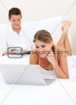 Loving couple relaxing on their bed