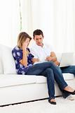 Upset couple at home angry with so many bills to pay