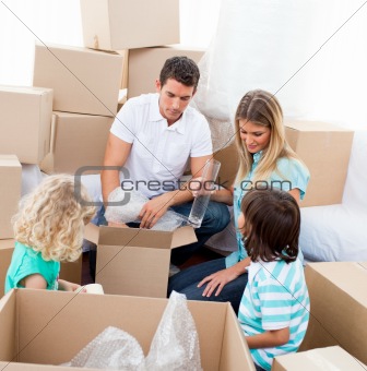 Happy family moving house playing with boxes