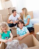 Cheerful family packing boxes