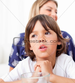  Captivated child watching television with his mother