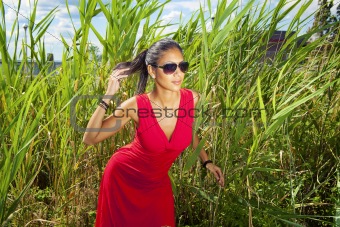 young female red dress in grass 