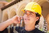 Handsome Hispanic Contractor with Hard Hat Talking on His Cell Phone.