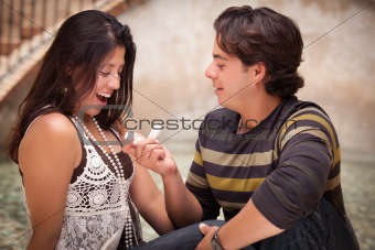 Hispanic Man Proposing with an Engagement Ring to His Love.