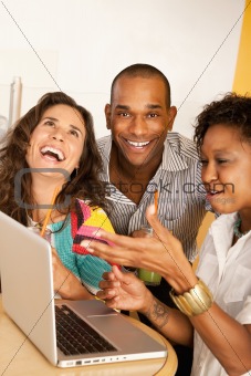 Three People Dining Out Using a Laptop