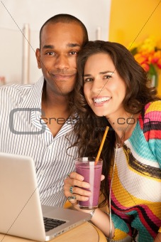 Couple Dining Out Using a Laptop