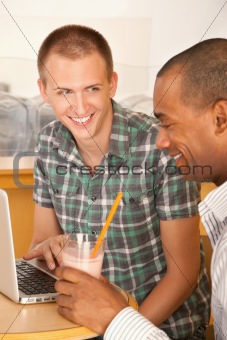 Two Men at Cafe Using Laptop