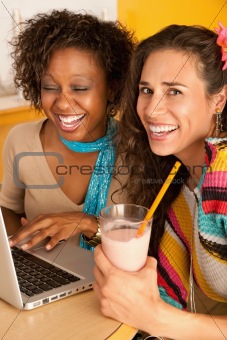 Two Women at Cafe Using Laptop
