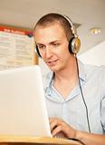 Young Man with Laptop and Headphones