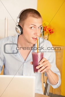 Young Man with Laptop and Headphones