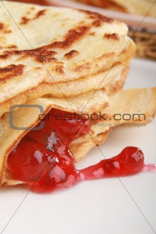 stack of pancakes filled with red jam