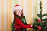 girl decorating christmas tree