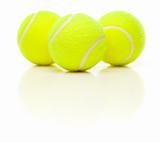 Three Tennis Balls with Slight Reflection Isolated on a White Background.