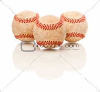 Three Baseballs Isolated on a Reflective White Background.