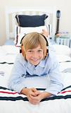 Smiling blond boy listening to music