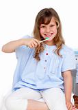 Portrait of a little girl brushing her teeth