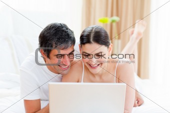 Affectionate couple using a laptop 