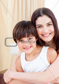Smiling mother hugging her son 