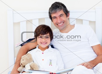Happy father reading with his son 