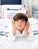 Cute little boy listening music with headphones on