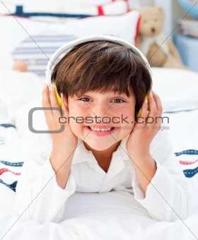 Happy little boy listening music with headphones on
