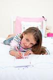 Cute Little girl writing on a notebook 